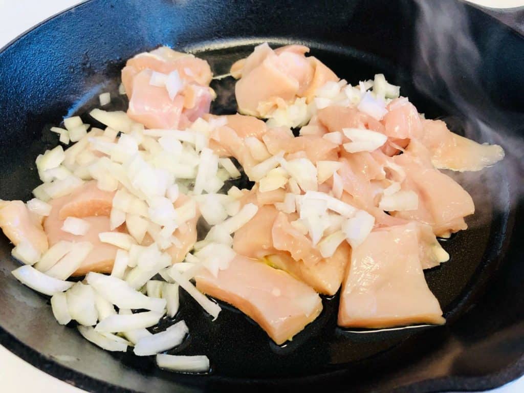 chicken and onions cooking in skillet